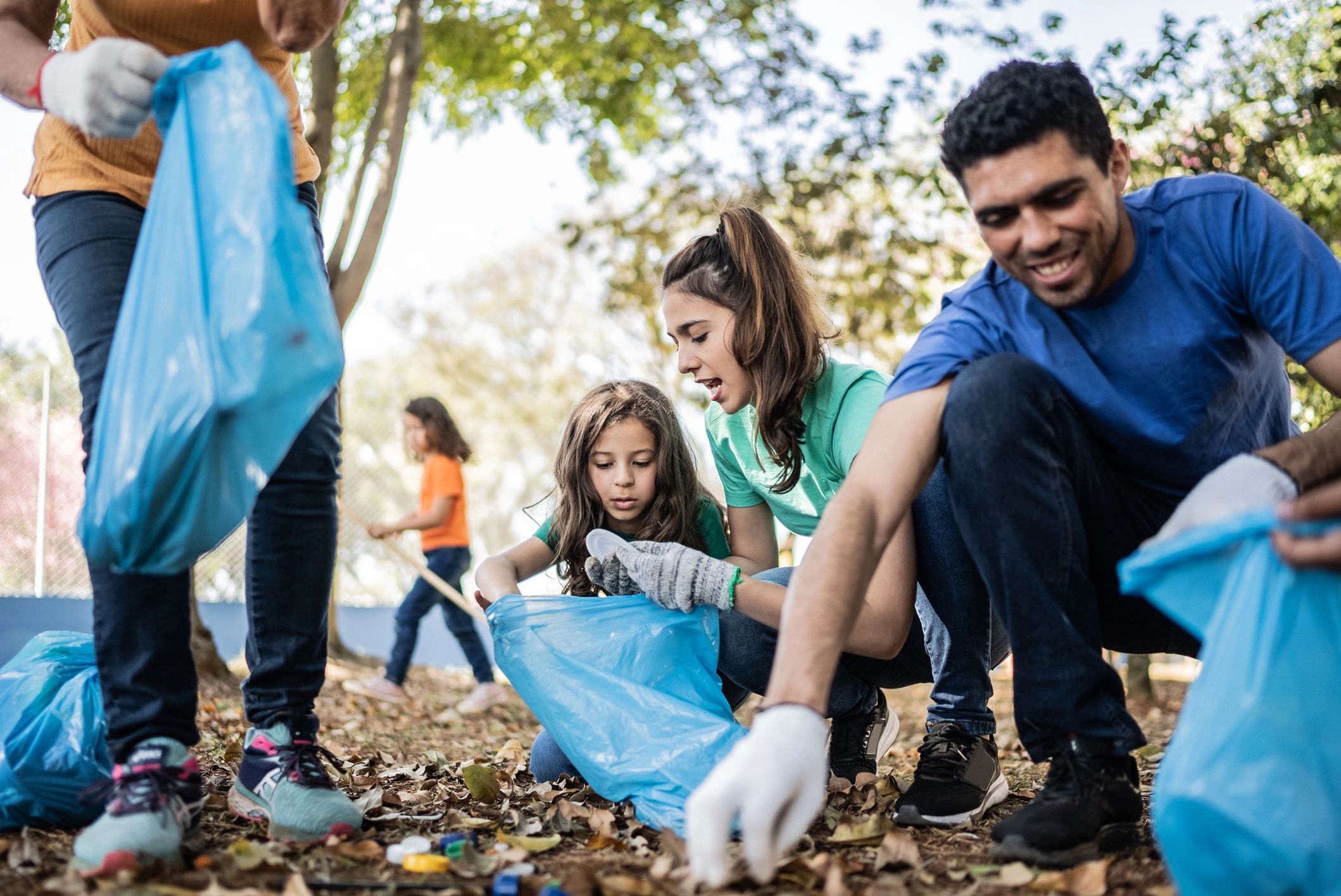 Volunteers cleaning a public park during a community service project