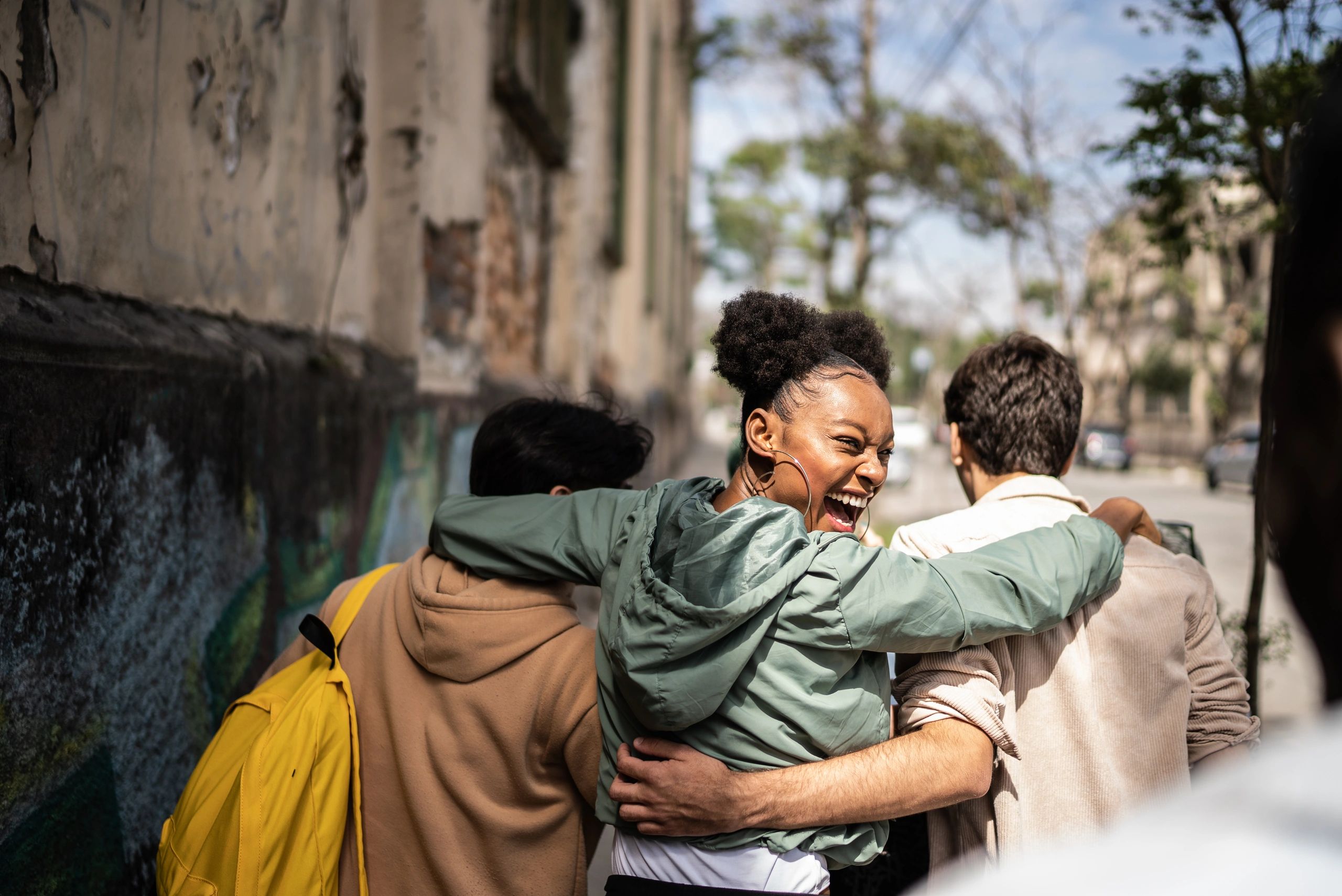 Young woman walking with friends in a community setting