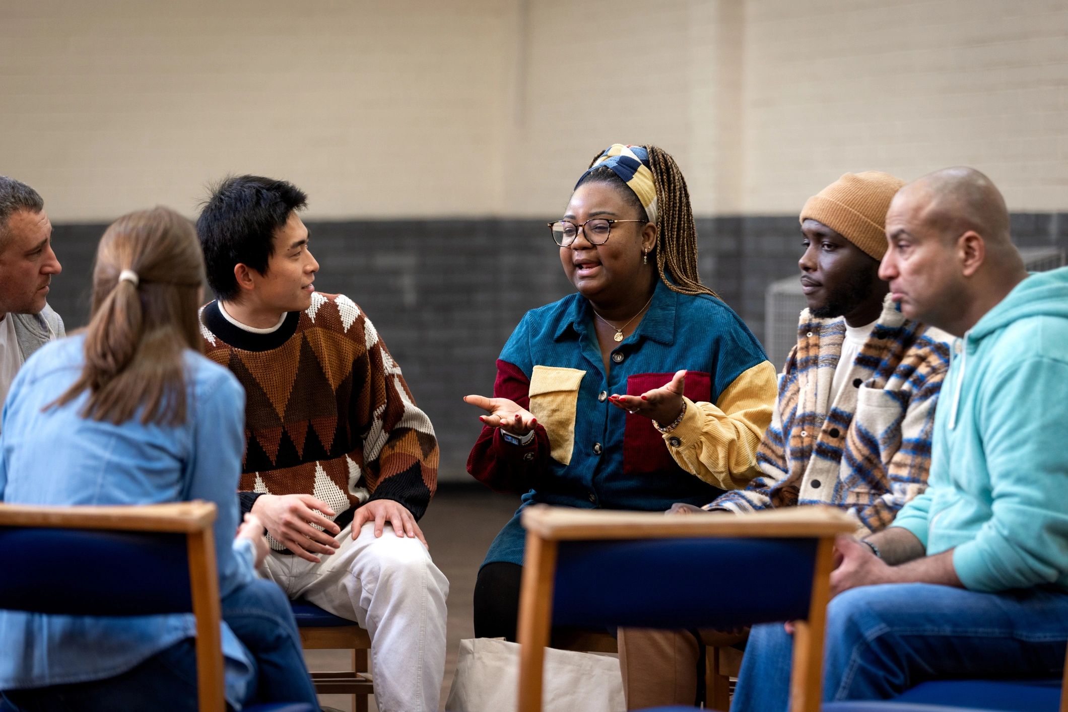 Adults in a community circle conversation