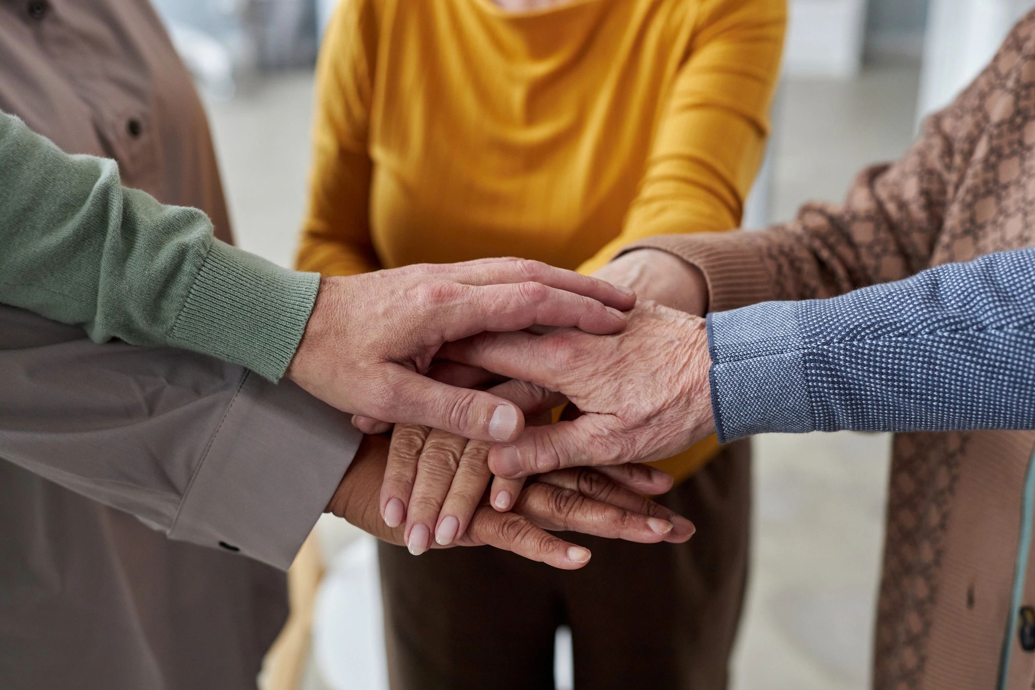 Hands joined together to represent charitable giving and support