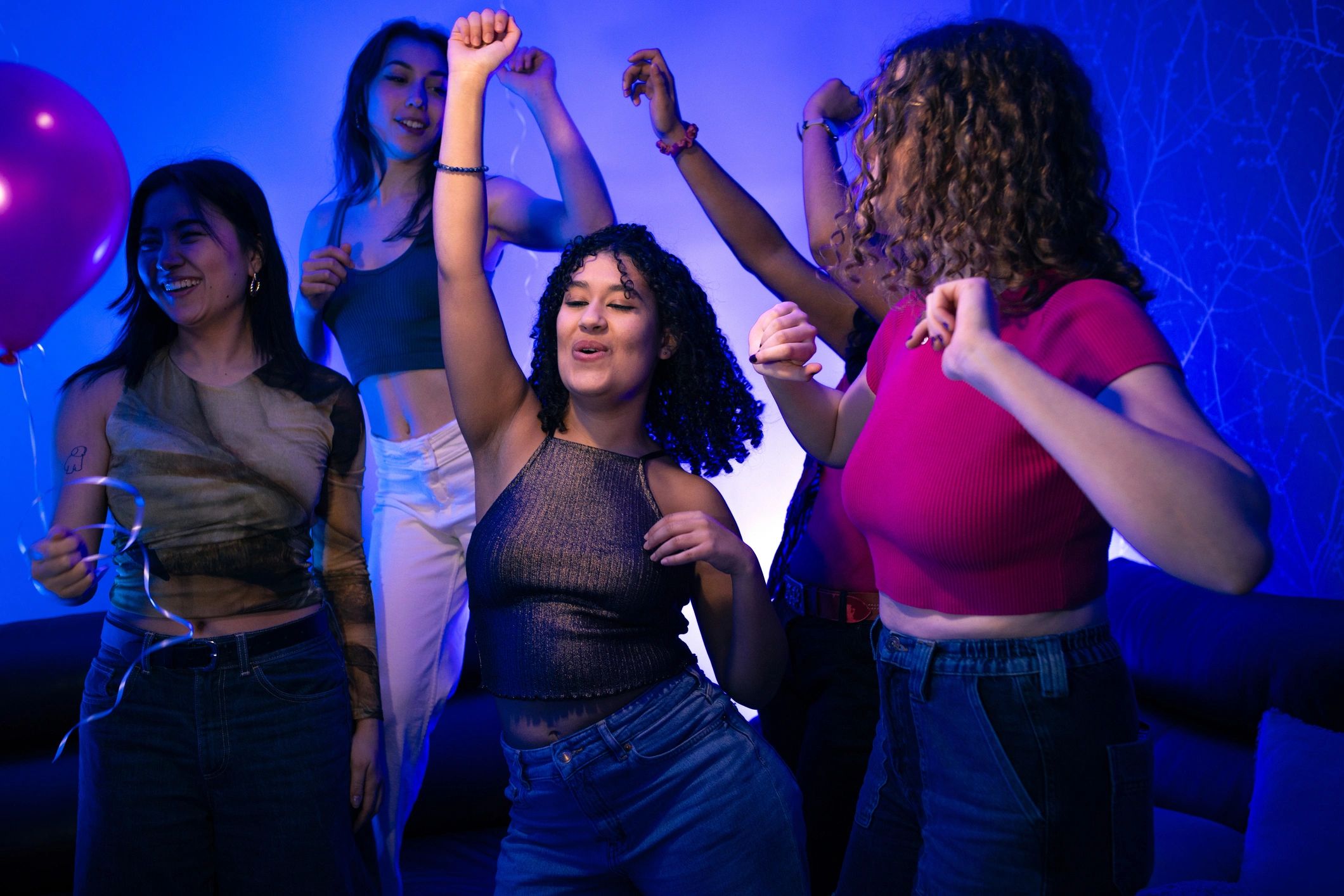 Young adults dancing together in a joyful group setting