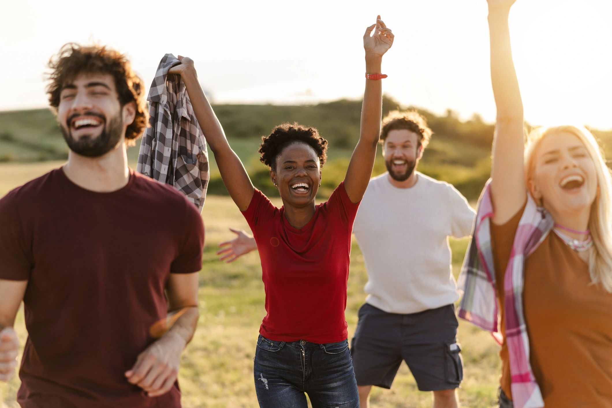 Friends celebrating outdoors at sunset